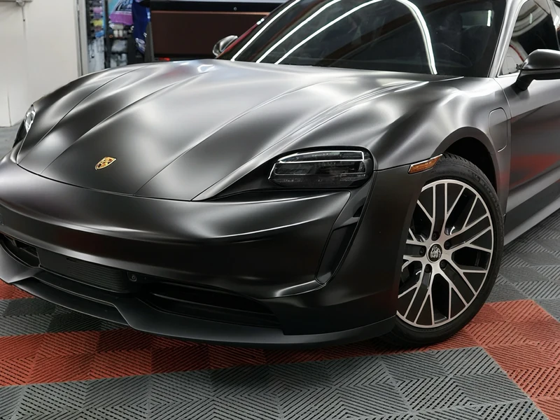 Porsche Taycan in satin black vinyl wrap with ceramic coating