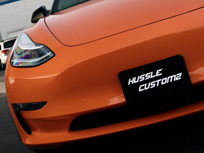 Tesla Model 3 Gloss Orange Vinyl Wrap — photo 2 — Hussle Customz Los Angeles