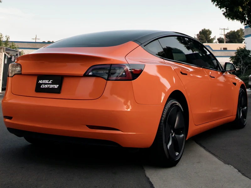 Tesla Model 3 Gloss Orange Vinyl Wrap — photo 3 — Hussle Customz Los Angeles