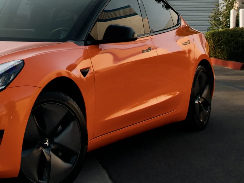Tesla Model 3 Gloss Orange Vinyl Wrap — photo 4 — Hussle Customz Los Angeles