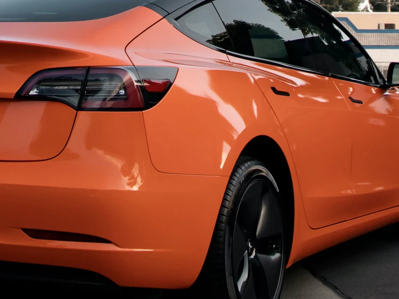 Tesla Model 3 Gloss Orange Vinyl Wrap — photo 5 — Hussle Customz Los Angeles